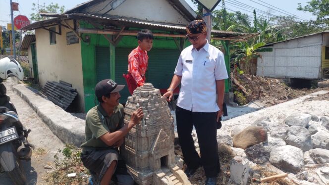 
					Sekretaris Disdikbud Kabupaten Probolinggo bersama warga melihat benda mirip candi.