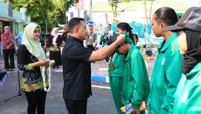 
					APRESIASI:  Pj. Walikota Probolinggo, M. Taufik Kurniawan mengalungkan bungan dan medali ke atlet berprestasi dalam ajang PON ke-21. (istimewa)