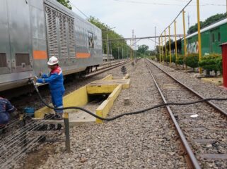 EFISIENSI: Petugas mengisi BBM ke lokomotif dan kereta pembangkit. (foto: Istimewa)
