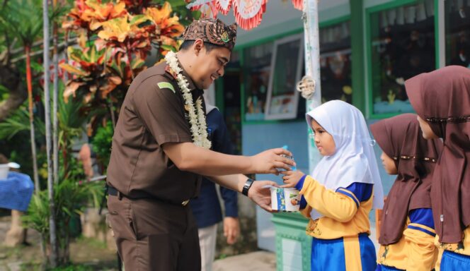 
					BERBAGI: Kejari Kabupaten Probolinggo, Ahmad Nuril Alam, saat memberikan MBG ke siswi SDN 1 Sebaung. (foto: Ali Ya'lu).