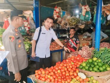 SIDAK: Kabid Perdagangan DKUPP Kabupaten Probolinggo, Mahdinsareza, saat mengecek sejumlah harga bahan kebutuhan di salah satu lapak Pasar Maron. (foto: Ali Ya'lu).