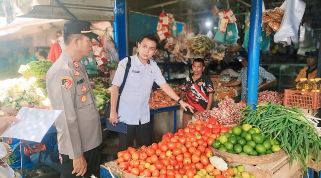 SIDAK: Kabid Perdagangan DKUPP Kabupaten Probolinggo, Mahdinsareza, saat mengecek sejumlah harga bahan kebutuhan di salah satu lapak Pasar Maron. (foto: Ali Ya'lu).